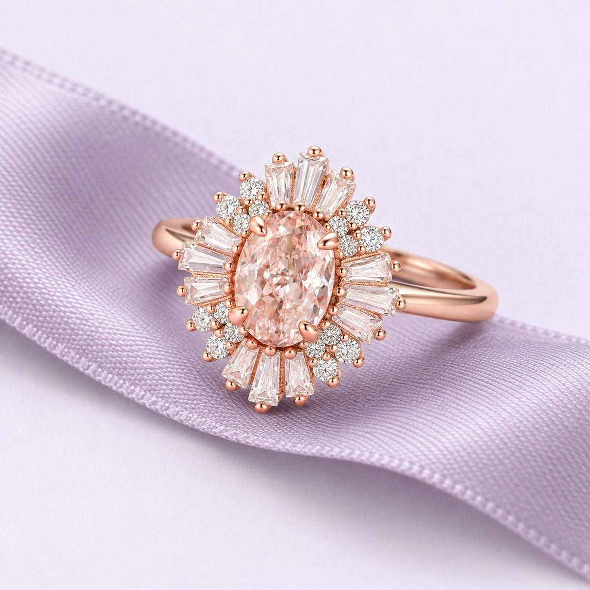 Rose-gold Victoria ring with a peach morganite center and Art Deco halo, resting on continuous dusty lavender silk.