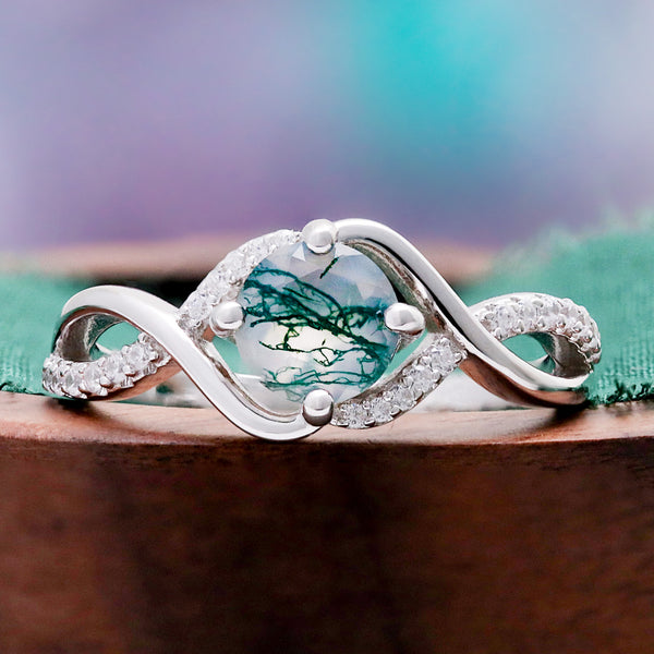 Entwined green moss agate ring in sterling silver, close-up view