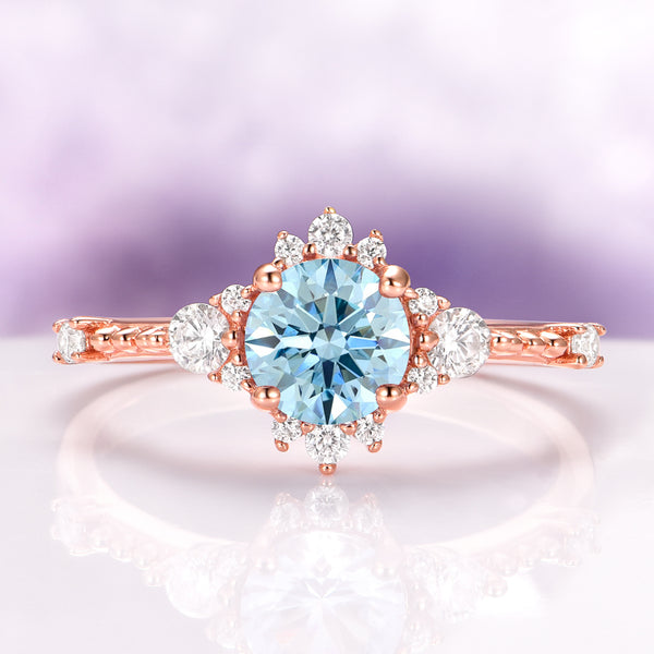 Round Cut Aquamarine Engagement Ring in 14K Solid Rose Gold featuring a vintage-inspired design with a central aquamarine surrounded by sparkling accent stones by Aquamarise Gold.