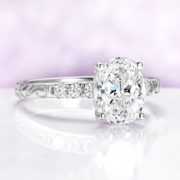 Diamond ring with intricate band on a reflective surface with a light purple background