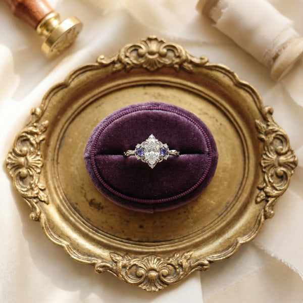 Ring on a purple cushion in an ornate gold ring box