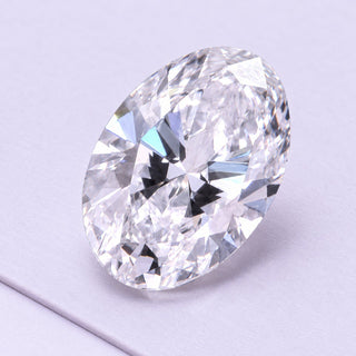 Oval loose lab-grown diamond in a close diagonal view, resting on pale lilac matte tiles under soft daylight.