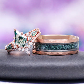 Two rose gold rings with green gemstones on a gray surface with a purple gradient background