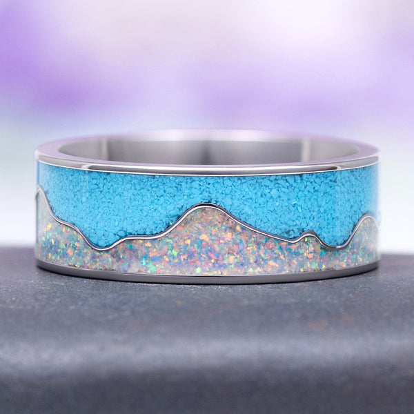 Turquoise & Fire Opal Mountain Wedding Band in Titanium (8mm) by Aquamarise features a mountain-inspired design with vibrant crushed turquoise and iridescent fire opal inlays set in lightweight, durable titanium, ideal for men's wedding bands and October birthstone collections.