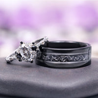 Esme Gray Moissanite and Meteorite Couples Ring Set featuring a marquise-cut moissanite with black accents on a textured silver band paired with a wide black tungsten carbide ring inlaid with meteorite, by Aquamarise.