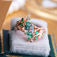 Emerald Leaf Ring Guard in 14K Solid Rose Gold by Aquamarise Gold, featuring intricate leaf and vine design with lab-grown emeralds and sparkling accents for nature-inspired elegance.