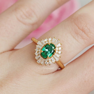 Victoria Vintage Emerald Couples Ring Set featuring a gold band with a green emerald center stone surrounded by sparkling baguette and round diamonds, by Aquamarise.