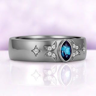 Angled view of the alexandrite celestial band, showing the teal to violet color of the stone and the milgrain-edged moons