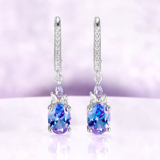 Alexandrite Earrings Oval Color Changing Alexandrite over light purple background