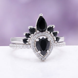 Angled view of the pear black onyx ring with sparkling accent stones