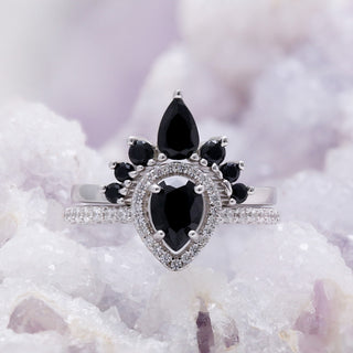 Amy black onyx ring set worn on hand against a neutral background