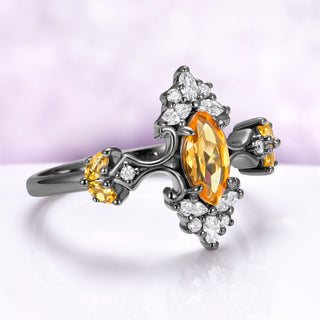 Angled view of the blackened scrollwork, citrine shoulder clusters and slim 1.7 mm band