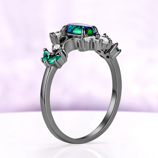Side profile of the Artemisia peacock fire opal ring in black ruthenium, the domed opal sitting low on a slim band
