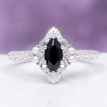 Arwen Black Onyx & Pearl Couples Ring Set by Aquamarise, featuring a marquise black onyx center with pearl clusters and delicate silver detailing on a textured sterling silver band.