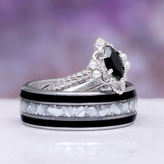 Arwen Black Onyx & Pearl Couples Ring Set by Aquamarise, featuring a marquise black onyx with pearl accents and a matching band with white and black stone inlays, crafted for couples.