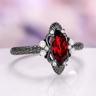 Ring with a red gemstone and pearls on a white background