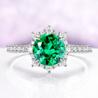 Emerald Engagement Ring Round Emerald Halo Ring over light purple background 