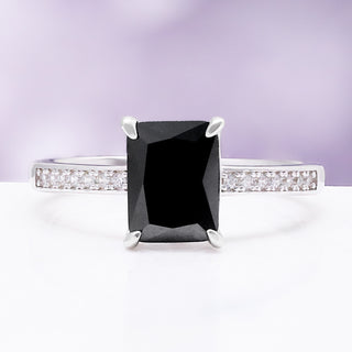 Black onyx engagement ring — emerald cut onyx solitaire in rhodium-finished sterling silver with pavé shoulders