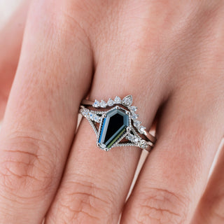 White gold engagement ring set with coffin cut black diamond center stone and accents on hand 