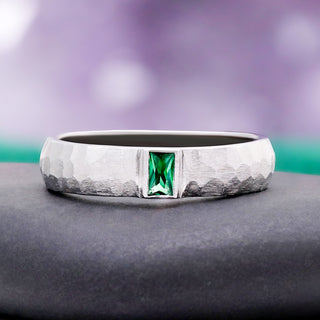 Bezel Emerald Hammered Wedding Band in Sterling Silver (5.5mm) by Aquamarise, styled against teal to highlight the emerald accent.