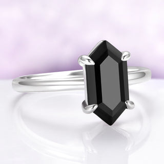 Silver ring with a black gemstone on a white background