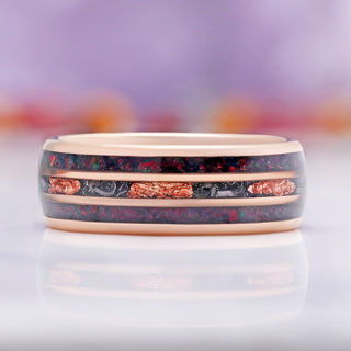 Close-up of the meteorite and black fire opal inlay on rose gold tungsten