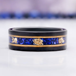 Blue Sapphire & Gold Leaf Brushed Men's Wedding Band in Black Tungsten (8mm) by Aquamarise, with crushed blue sapphire and gold leaf set in a black band.