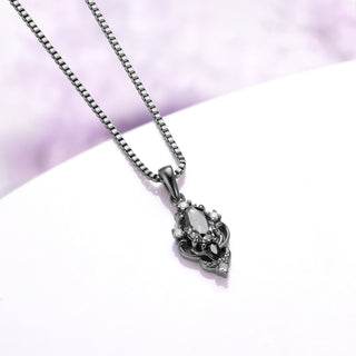 Angled view of the Carmilla gray moissanite pendant showing the tapered bail, carved scroll frame and box chain