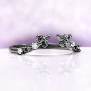 Angled view of the black ruthenium Carmilla ring enhancer showing the open front and carved leaf terminals