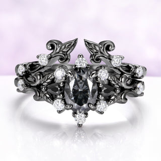 The black ruthenium Carmilla ring enhancer wrapped around a matching gray moissanite engagement ring