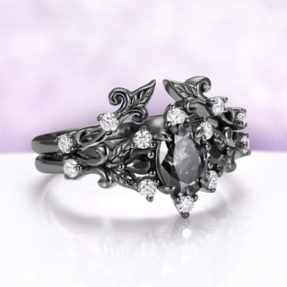 Angled view of the black ruthenium Carmilla enhancer worn together with an engagement ring on one finger