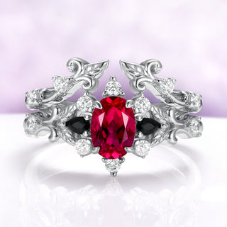 Carmilla ruby and black onyx bridal ring set in sterling silver, oval lab-grown ruby nested inside the leaf and vine enhancer band