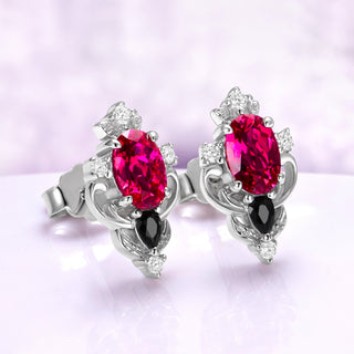 Angled view of the Carmilla ruby studs showing the butterfly push-backs, black onyx drop and cubic zirconia accents