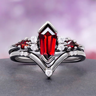 Coffin Kite Natural Red Garnet Ring Set in Black Ruthenium by Aquamarise, a coffin-cut red garnet with marquise garnet accents on a black chevron band.