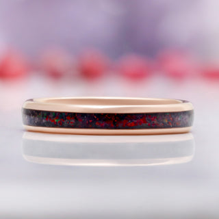 Close-up of the crushed black fire opal inlay on the rose gold band