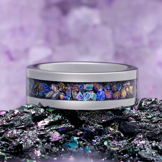 Crushed Rainbow Men's Wedding Band in Black Tungsten Carbide (8mm) by Aquamarise, styled on iridescent rough stone.