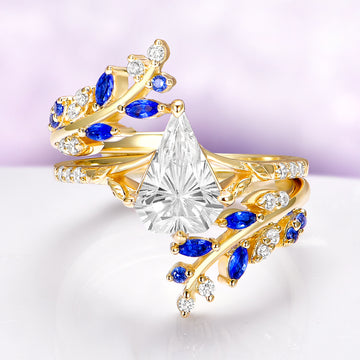 Blue Sapphire & Fantasy Shield Cut Diamond Couples Ring Set by Aquamarise featuring a yellow gold band with marquise sapphires and a shield-cut cz diamond in an intricate fantasy-inspired design.
