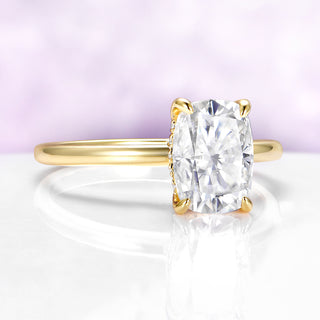 Gold ring with a large diamond on a white and purple gradient background