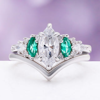 Emerie Diamond & Emerald Engagement Ring by Aquamarise, a marquise diamond flanked by marquise emeralds on a rhodium-finished chevron band.