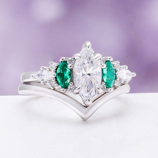 Emerie Diamond & Emerald Engagement Ring by Aquamarise, angled view showing the marquise diamond and emerald side stones.
