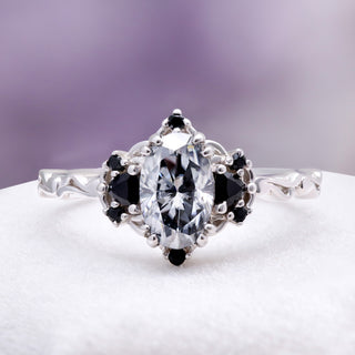 Esme Gray Moissanite Ring by Aquamarise, with an oval grey moissanite flanked by black onyx accents on a rhodium-finished band.