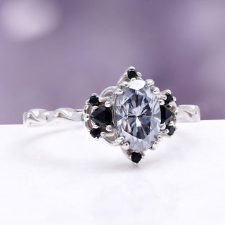 Esme Gray Moissanite Ring by Aquamarise, angled view showing the oval grey moissanite between black onyx side stones.