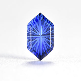 Faelight Cut lab-grown blue sapphire long hexagon 5 x 9 mm loose gemstone, concave starburst facets, on white