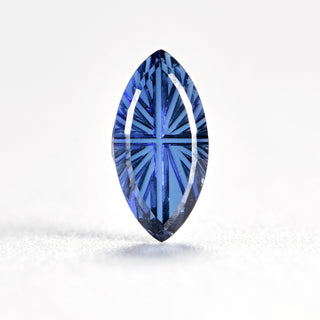 Faelight Cut lab-grown blue sapphire marquise 5 x 10 mm loose gemstone, concave starburst facets, on white