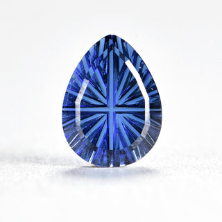 Faelight Cut lab-grown blue sapphire pear 6 x 8 mm loose gemstone, concave starburst facets, on white