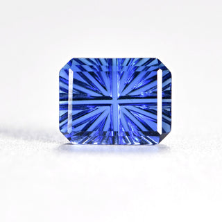 Faelight Cut lab-grown blue sapphire rectangle 6 x 8 mm loose gemstone, concave starburst facets, on white