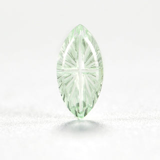 Faelight Cut lab-grown green sapphire marquise 5 x 10 mm loose gemstone, concave starburst facets, on white