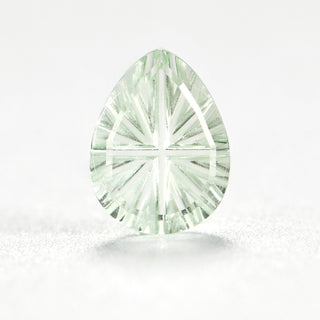 Faelight Cut lab-grown green sapphire pear 6 x 8 mm loose gemstone, concave starburst facets, on white