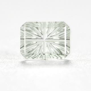 Faelight Cut lab-grown green sapphire rectangle 6 x 8 mm loose gemstone, concave starburst facets, on white