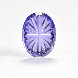 Faelight Cut lab-grown lavender purple sapphire oval 6 x 8 mm loose gemstone, concave starburst facets, on white